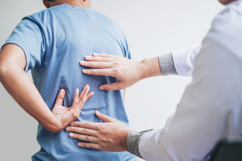 Doctor consulting with patient Back problems Physical therapy co Physical therapy